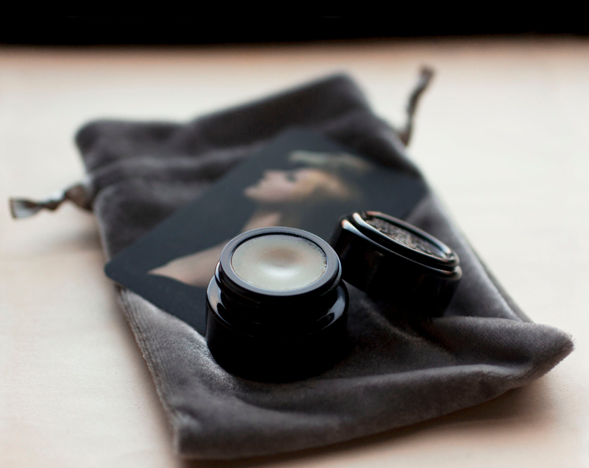 Figure 1: Noir Solid Perfume in Round Violet Jar